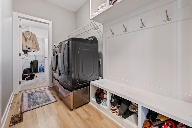 5397 Brook View Ave, Des Moines, IA 50317 - laundry room featuring washing machine and clothes dryer and wood finished floors
