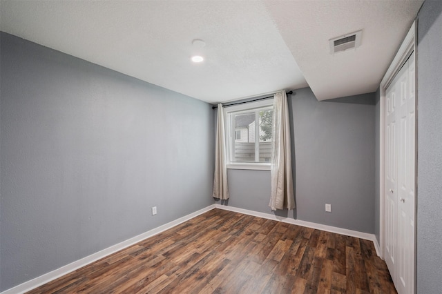 5397 Brook View Ave, Des Moines, IA 50317 - unfurnished bedroom with dark wood finished floors and a closet
