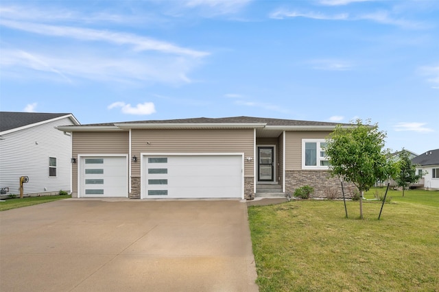 5397 Brook View Ave, Des Moines, IA 50317 - view of front of property featuring driveway, a garage, a front lawn, and stone siding