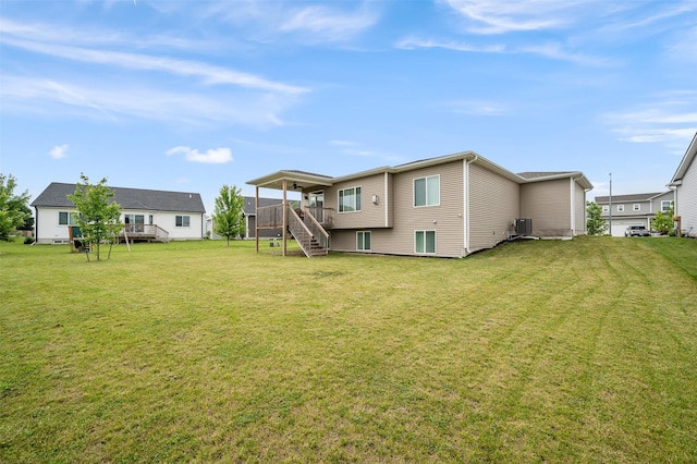 5397 Brook View Ave, Des Moines, IA 50317 - back of house featuring stairway, a deck, and a yard