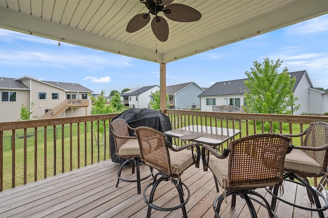 5397 Brook View Ave, Des Moines, IA 50317 - deck with a residential view, outdoor dining space, a lawn, and a ceiling fan
