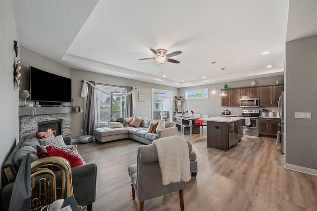 5397 Brook View Ave, Des Moines, IA 50317 - living area featuring ceiling fan, light wood-style floors, recessed lighting, and a stone fireplace