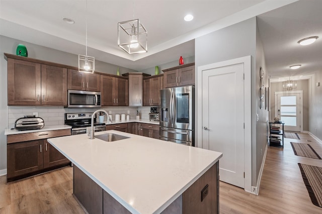 5397 Brook View Ave, Des Moines, IA 50317 - kitchen with stainless steel appliances, light wood-type flooring, light countertops, tasteful backsplash, and recessed lighting