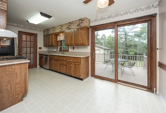 2217 Meadow Ln, West Des Moines, IA 50265 - kitchen featuring stainless steel dishwasher, light countertops, ceiling fan, and plenty of natural light