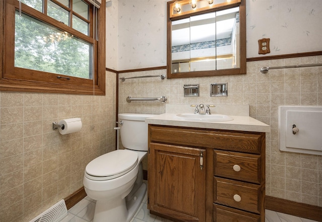 2217 Meadow Ln, West Des Moines, IA 50265 - half bathroom with tile walls, vanity, and a wainscoted wall