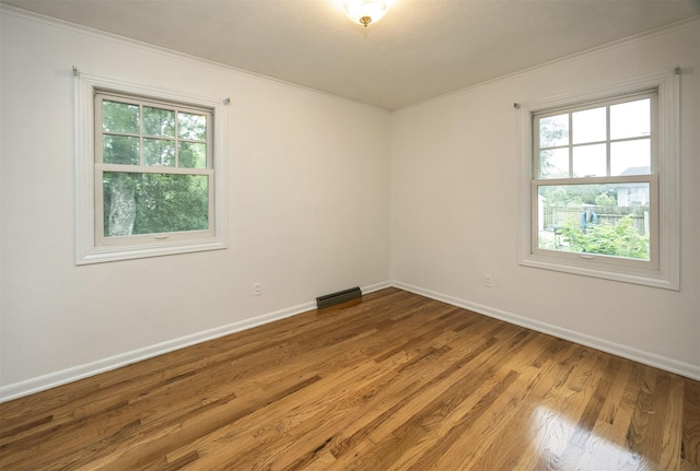2217 Meadow Ln, West Des Moines, IA 50265 - spare room featuring ornamental molding and wood finished floors