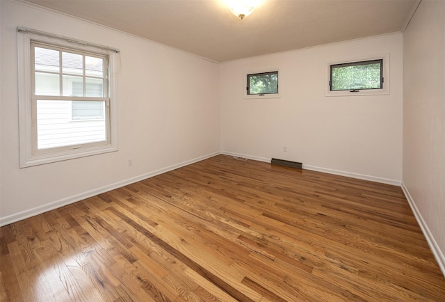 2217 Meadow Ln, West Des Moines, IA 50265 - spare room featuring plenty of natural light, wood finished floors, and crown molding