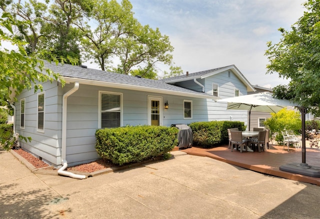 8786 Primrose Ln, Clive, IA 50325 - view of front of house with a deck, outdoor dining space, and a shingled roof