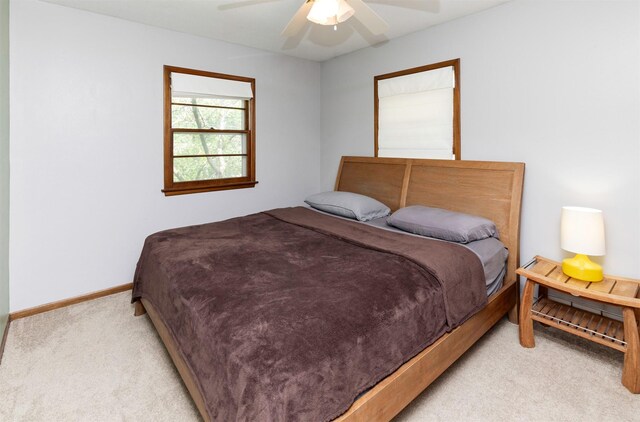 8786 Primrose Ln, Clive, IA 50325 - bedroom with light carpet and ceiling fan