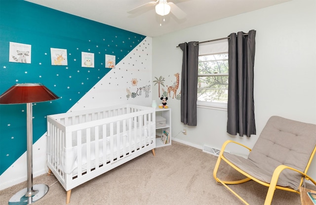 8786 Primrose Ln, Clive, IA 50325 - carpeted bedroom with a crib and a ceiling fan