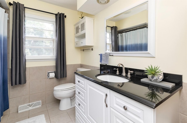 8786 Primrose Ln, Clive, IA 50325 - bathroom with vanity, tile patterned flooring, tile walls, and wainscoting