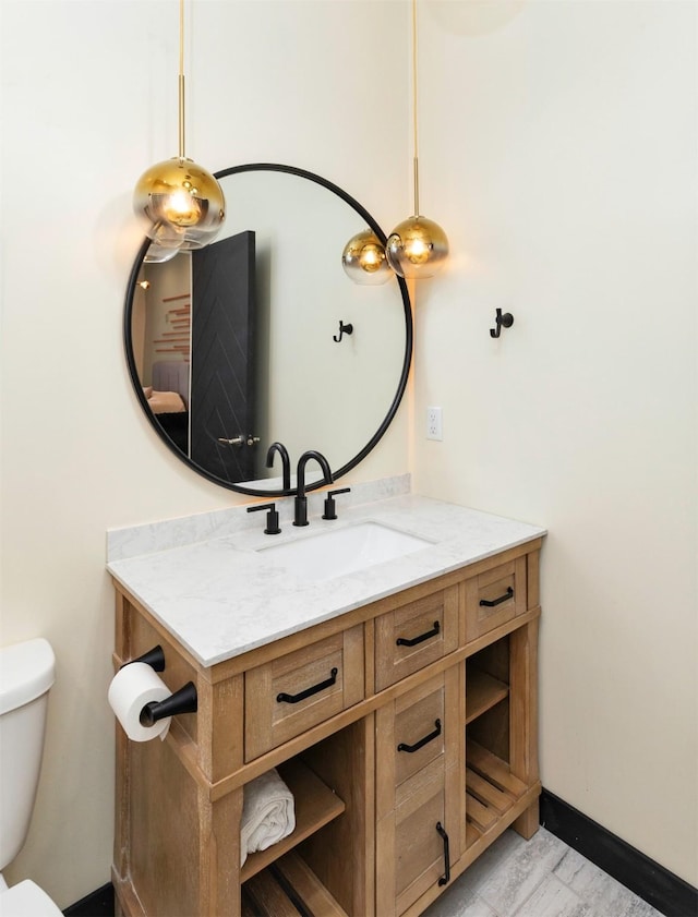 400 E Locust St Unit 102, Des Moines, IA 50309 - half bathroom featuring vanity and toilet