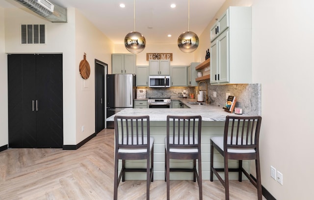 400 E Locust St Unit 102, Des Moines, IA 50309 - kitchen featuring stainless steel appliances, a peninsula, backsplash, recessed lighting, and open shelves