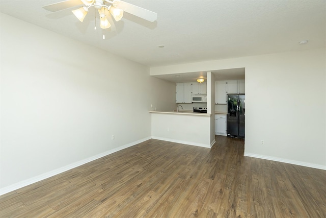 2240 Hart Ave Unit 4, Des Moines, IA 50320 - unfurnished living room with dark wood-type flooring and a ceiling fan