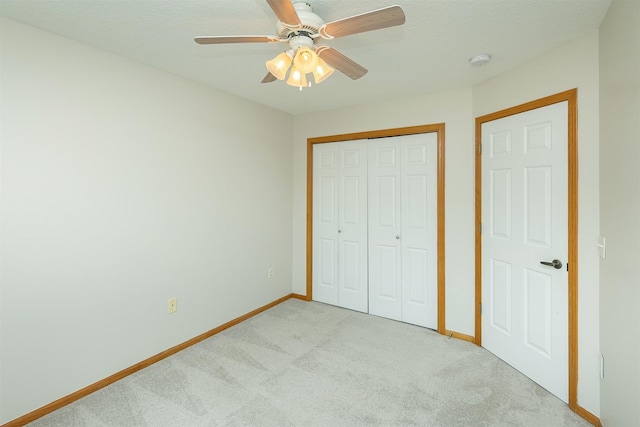2240 Hart Ave Unit 4, Des Moines, IA 50320 - unfurnished bedroom featuring light carpet, a closet, and a ceiling fan