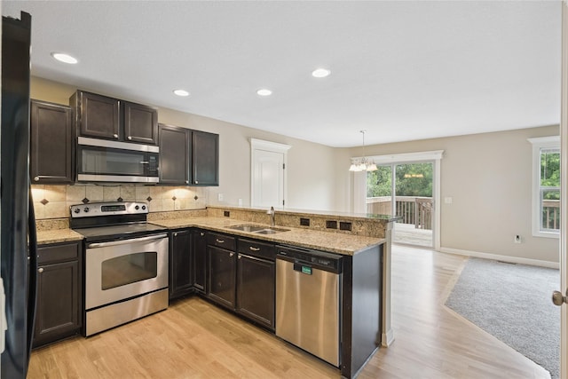 16205 Monroe Ct, Urbandale, IA 50323 - kitchen featuring appliances with stainless steel finishes, healthy amount of natural light, light wood finished floors, a chandelier, and recessed lighting