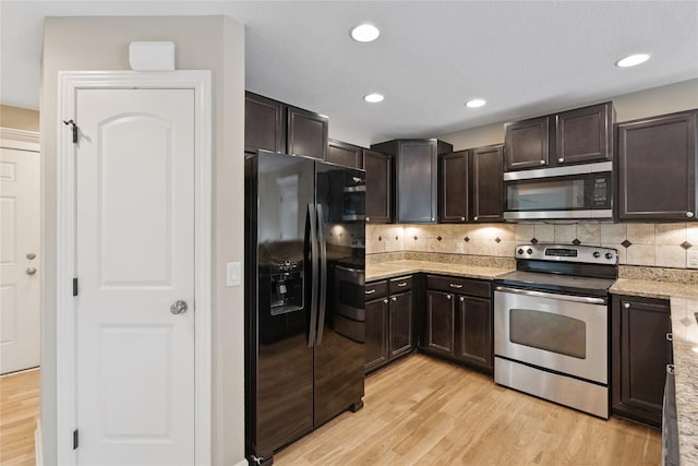 16205 Monroe Ct, Urbandale, IA 50323 - kitchen featuring appliances with stainless steel finishes, light wood-style floors, dark brown cabinets, decorative backsplash, and recessed lighting