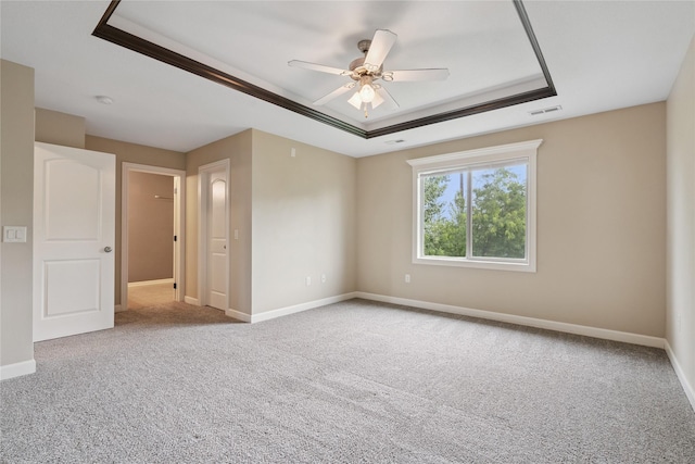 16205 Monroe Ct, Urbandale, IA 50323 - carpeted spare room featuring a tray ceiling, ceiling fan, and a smoke detector