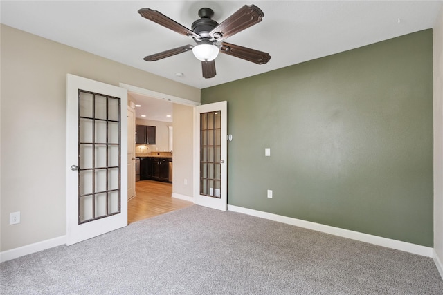 16205 Monroe Ct, Urbandale, IA 50323 - empty room with light carpet, a ceiling fan, and french doors