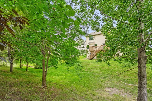 16205 Monroe Ct, Urbandale, IA 50323 - view of green lawn with stairs and a wooden deck