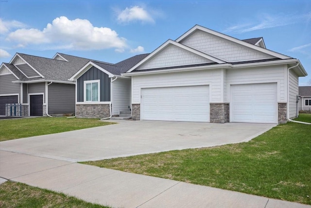 519 Alpha St NW, Bondurant, IA 50035 - craftsman-style house featuring stone siding, an attached garage, concrete driveway, and a front lawn