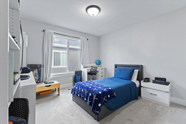 519 Alpha St NW, Bondurant, IA 50035 - carpeted bedroom featuring baseboards and a textured ceiling
