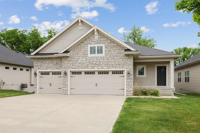 14335 Holcomb Ave, Urbandale, IA 50323 - view of front of property featuring stone siding, driveway, a garage, and a front yard