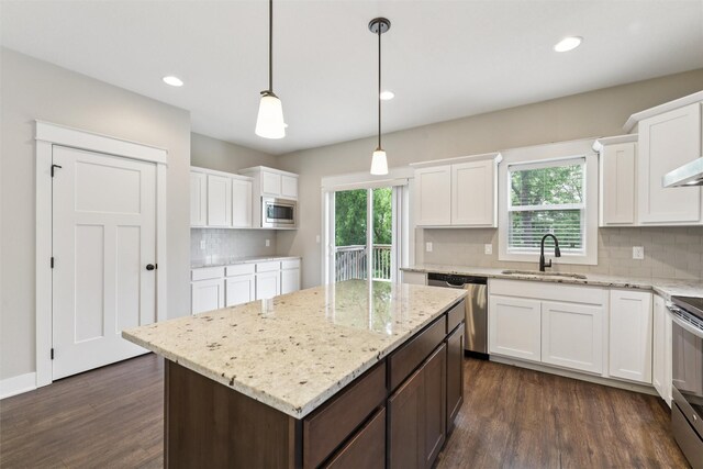 14335 Holcomb Ave, Urbandale, IA 50323 - kitchen with appliances with stainless steel finishes, white cabinets, backsplash, dark wood-style floors, and recessed lighting