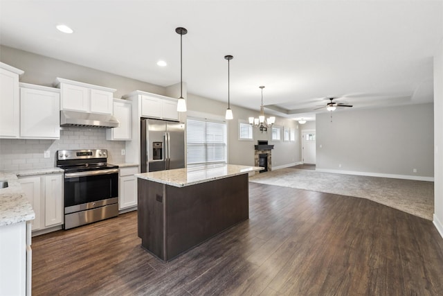 14335 Holcomb Ave, Urbandale, IA 50323 - kitchen with stainless steel appliances, under cabinet range hood, ceiling fan, tasteful backsplash, and white cabinets