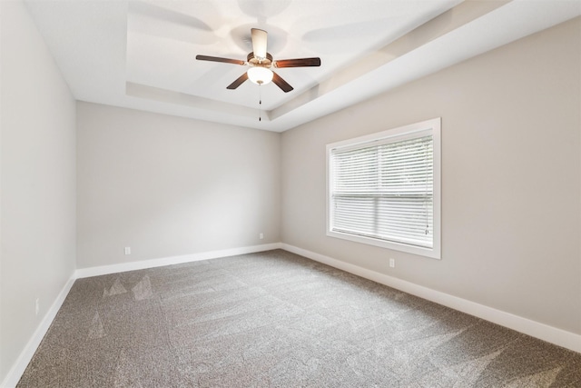 14335 Holcomb Ave, Urbandale, IA 50323 - carpeted empty room with a tray ceiling and a ceiling fan