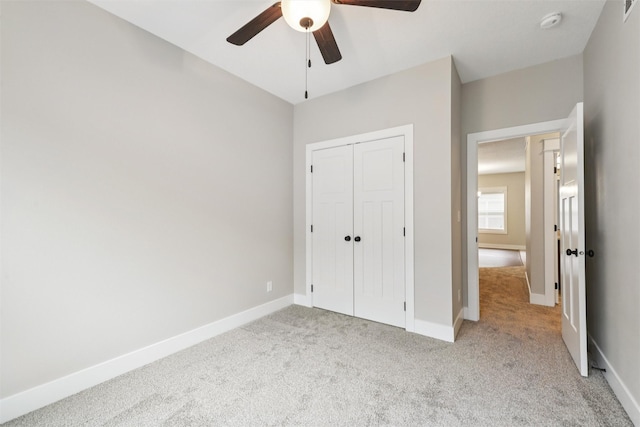 14335 Holcomb Ave, Urbandale, IA 50323 - unfurnished bedroom featuring light colored carpet, a closet, and a ceiling fan