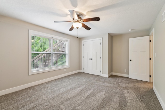 14335 Holcomb Ave, Urbandale, IA 50323 - unfurnished bedroom featuring carpet, a closet, and ceiling fan