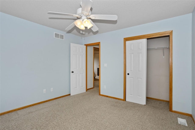 1201 NW Norton St, Grimes, IA 50111 - unfurnished bedroom featuring carpet, a closet, and a ceiling fan