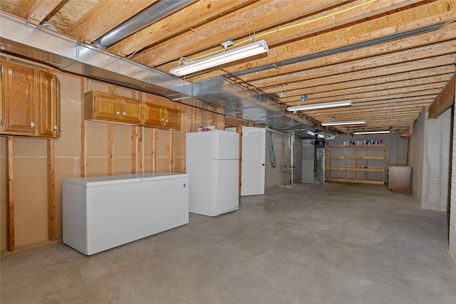 1201 NW Norton St, Grimes, IA 50111 - unfinished basement featuring freestanding refrigerator and refrigerator