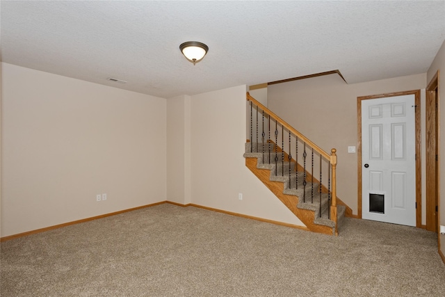 1201 NW Norton St, Grimes, IA 50111 - unfurnished living room featuring carpet flooring, stairway, and a textured ceiling