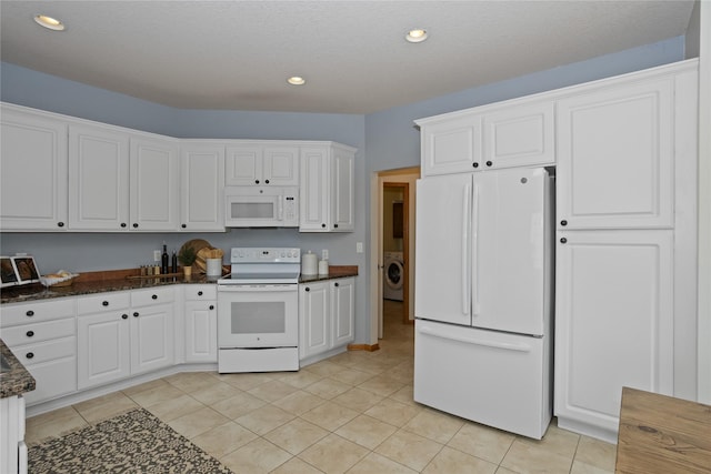 1201 NW Norton St, Grimes, IA 50111 - kitchen with white appliances, white cabinetry, washer / dryer, recessed lighting, and dark stone counters