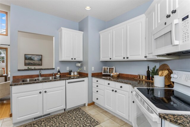 1201 NW Norton St, Grimes, IA 50111 - kitchen featuring white appliances, white cabinetry, light tile patterned flooring, dark stone counters, and recessed lighting