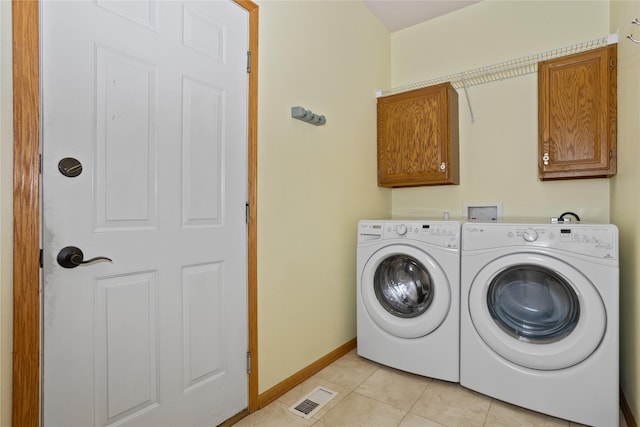 1201 NW Norton St, Grimes, IA 50111 - laundry room featuring cabinet space, washer and dryer, and light tile patterned floors