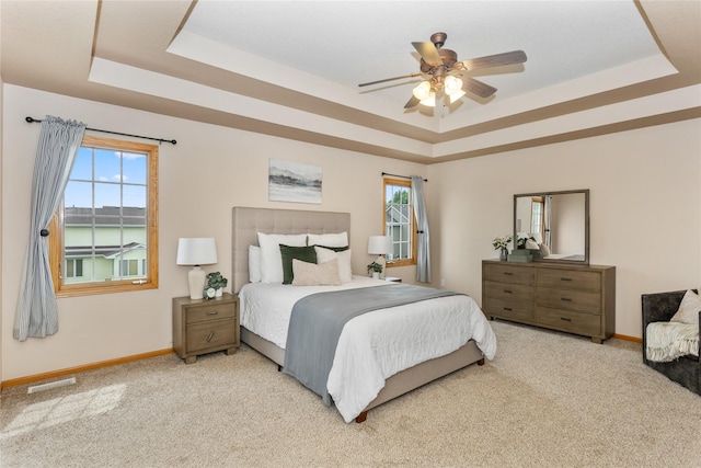 1201 NW Norton St, Grimes, IA 50111 - bedroom with a tray ceiling, light colored carpet, and ceiling fan