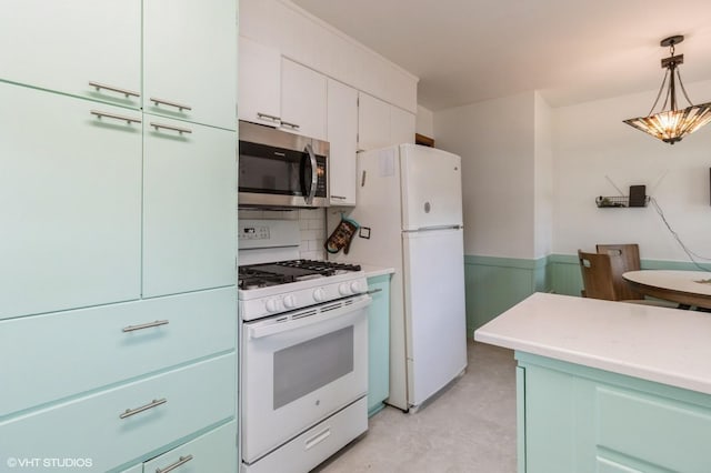 3709 Aurora Ave, Des Moines, IA 50310 - kitchen featuring white appliances, light countertops, pendant lighting, and white cabinets