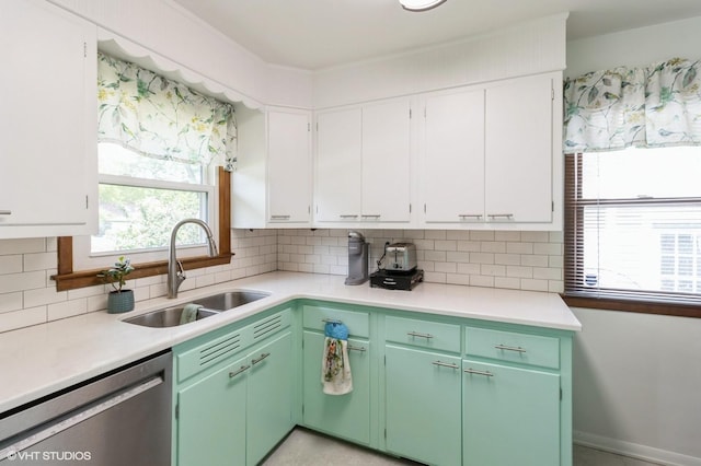 3709 Aurora Ave, Des Moines, IA 50310 - kitchen with stainless steel dishwasher, light countertops, healthy amount of natural light, and white cabinets