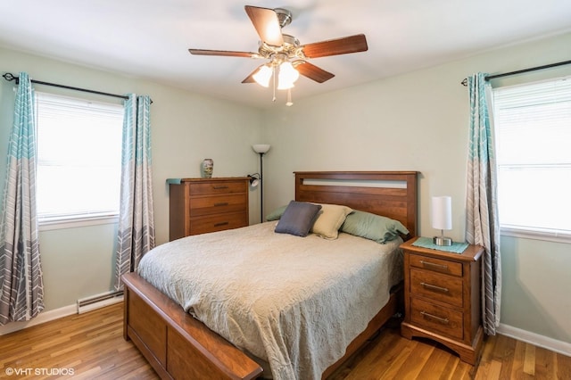 3709 Aurora Ave, Des Moines, IA 50310 - bedroom with multiple windows, light wood-style floors, and a ceiling fan