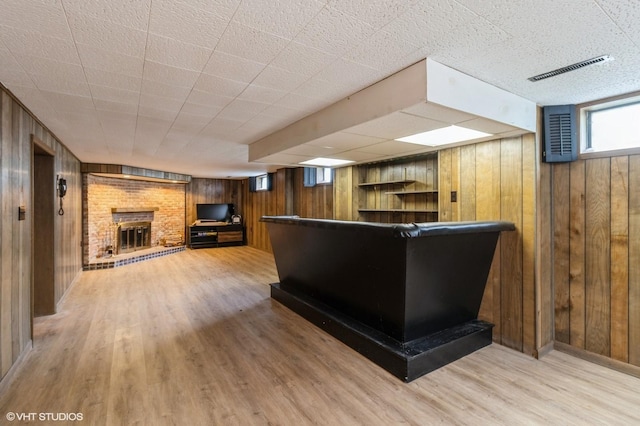 3709 Aurora Ave, Des Moines, IA 50310 - bar area with wooden walls, a brick fireplace, and wood finished floors
