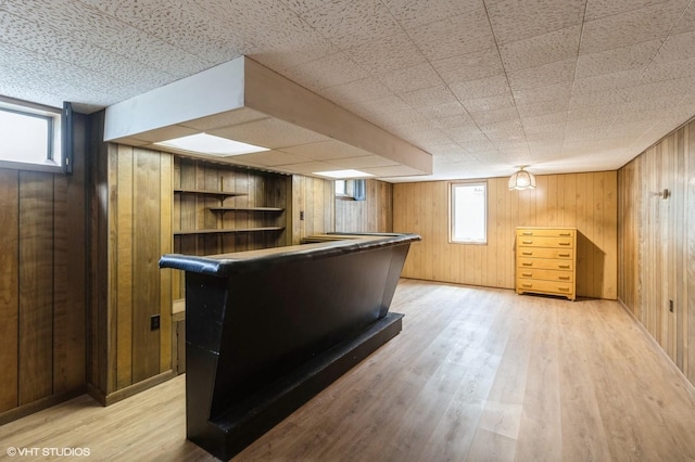 3709 Aurora Ave, Des Moines, IA 50310 - bar featuring wood walls, light wood-style floors, and healthy amount of natural light