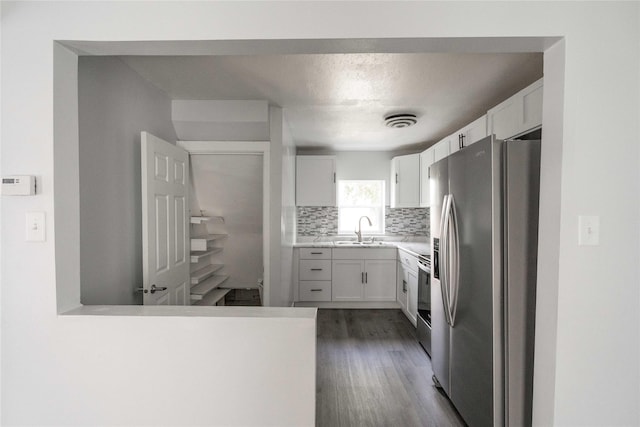 6325 NW 56th St, Johnston, IA 50131 - kitchen with stainless steel appliances, backsplash, dark wood-type flooring, and white cabinetry