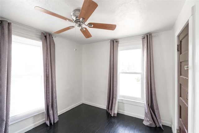 6325 NW 56th St, Johnston, IA 50131 - spare room with healthy amount of natural light, dark wood finished floors, ceiling fan, and a textured ceiling