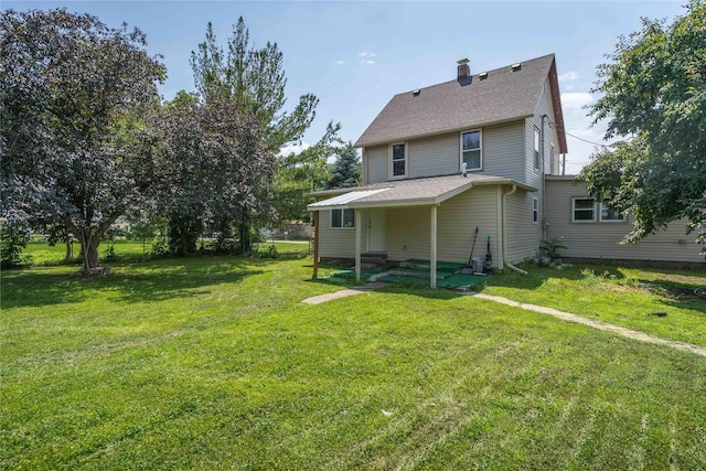 6325 NW 56th St, Johnston, IA 50131 - back of house featuring a yard, a chimney, and roof with shingles