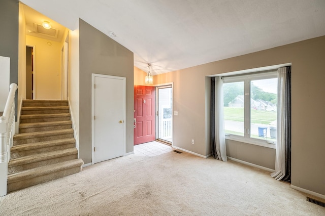 2316 SE 17th St, Des Moines, IA 50320 - unfurnished room with light colored carpet, vaulted ceiling, and stairway