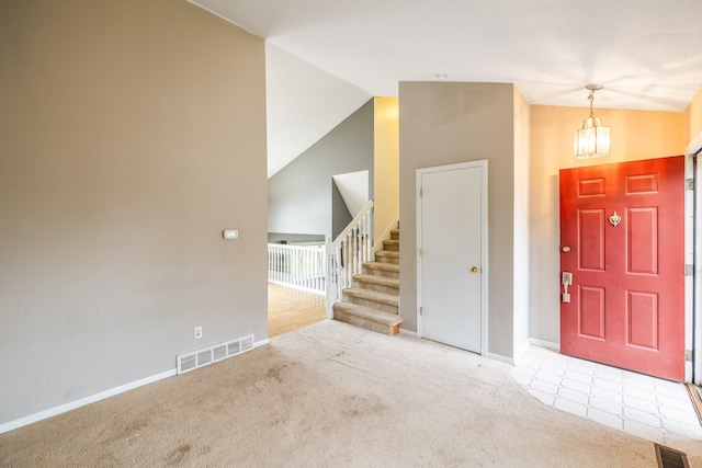 2316 SE 17th St, Des Moines, IA 50320 - foyer with carpet floors, stairs, high vaulted ceiling, and a chandelier