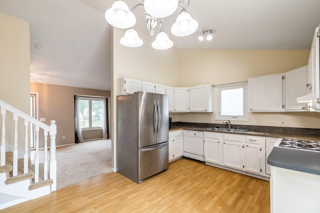 2316 SE 17th St, Des Moines, IA 50320 - kitchen featuring freestanding refrigerator, white dishwasher, dark countertops, high vaulted ceiling, and light wood-style flooring